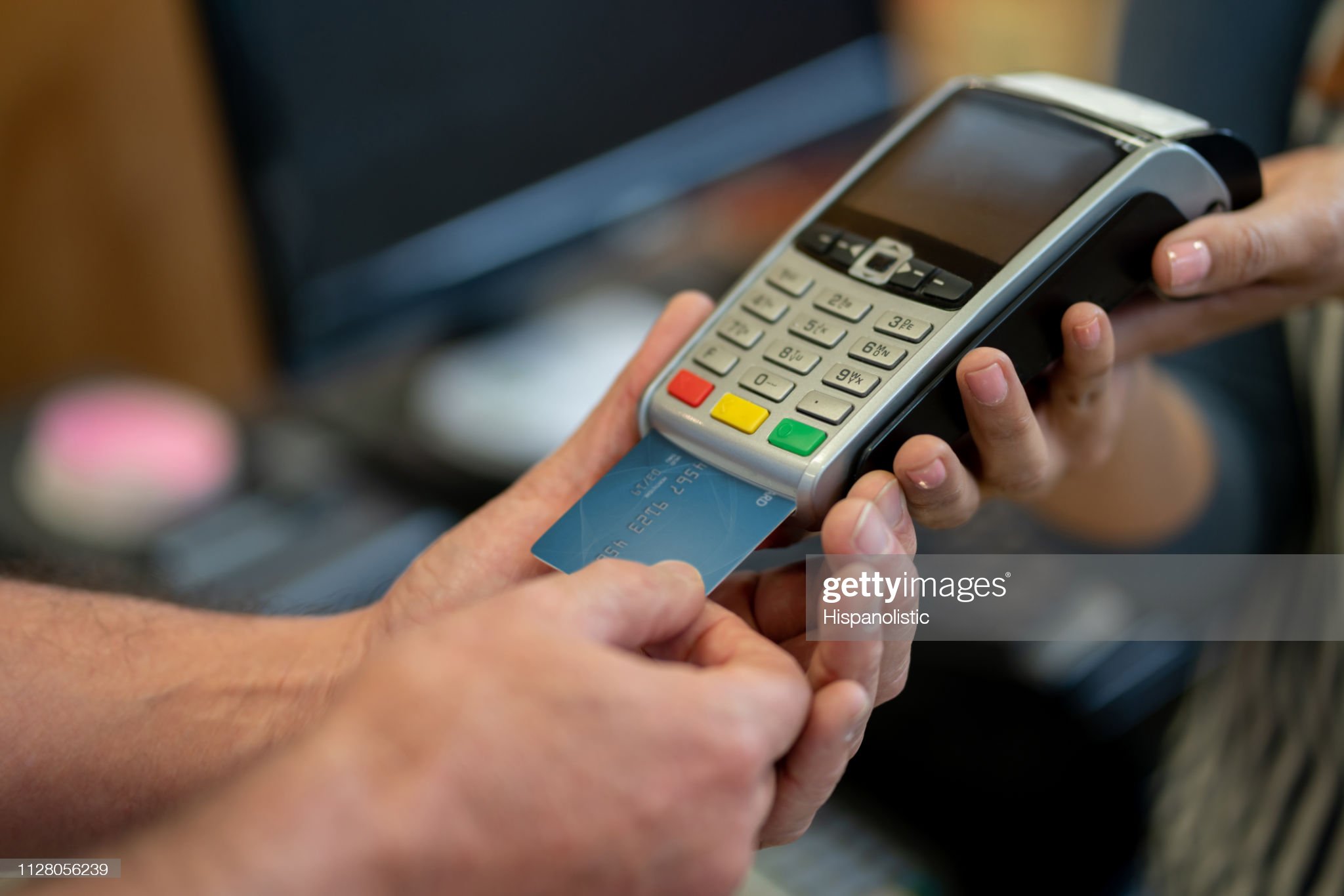 Close Up Of Unrecognizable Customer At A Food Market Paying With Credit Card **DESIGN ON CREDIT CARD WAS MADE FROM SCRATCH BY US**